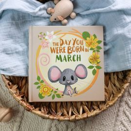 The book cover for Day You Were Born In March. A playful, illustrated mouse sat down surrounded by daffodils.
